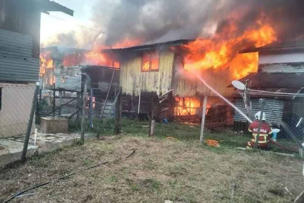 Pasukan bomba bertungkus lumus memadamkan api yang memusnah rumah di Kampung Kuala Abai, Kota Belud.