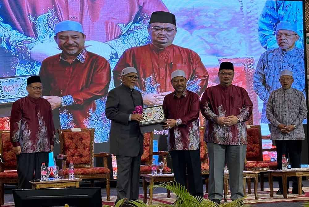Mohd Nassuruddin (tiga dari kiri) menyampaikan cenderamata penghargaan kepada Abdul Hadi.