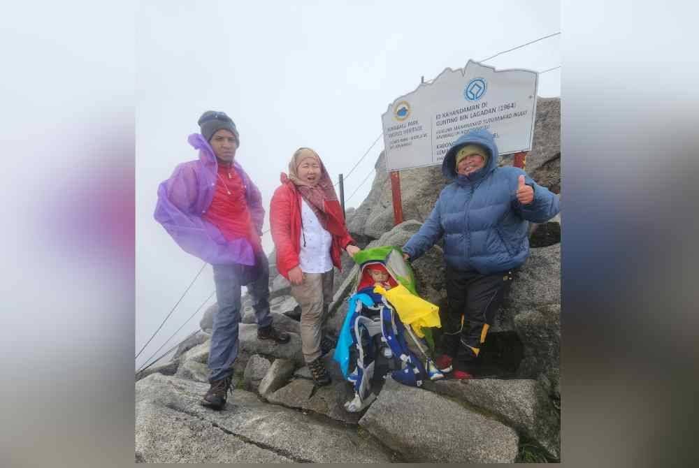 Amanda Omeychua tidak menjadikan penyakitnya itu sebagai penghalang untuk menggalas anak lelakinya yang berusia dua tahun enam bulan, menawan puncak tertinggi di Malaysia, Gunung Kinabalu, baru-baru ini. Foto Bernama