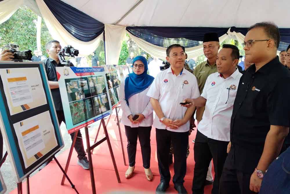 Isham (kanan) diberikan penerangan mengenai inisiatif yag akan dilaksanakan di kampung berkenaan.