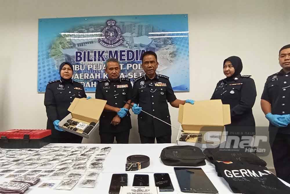 Fisol (tengah) menunjukkan pistol yang dirampas dalam sidang media di IPD Kota Setar pada Selasa.