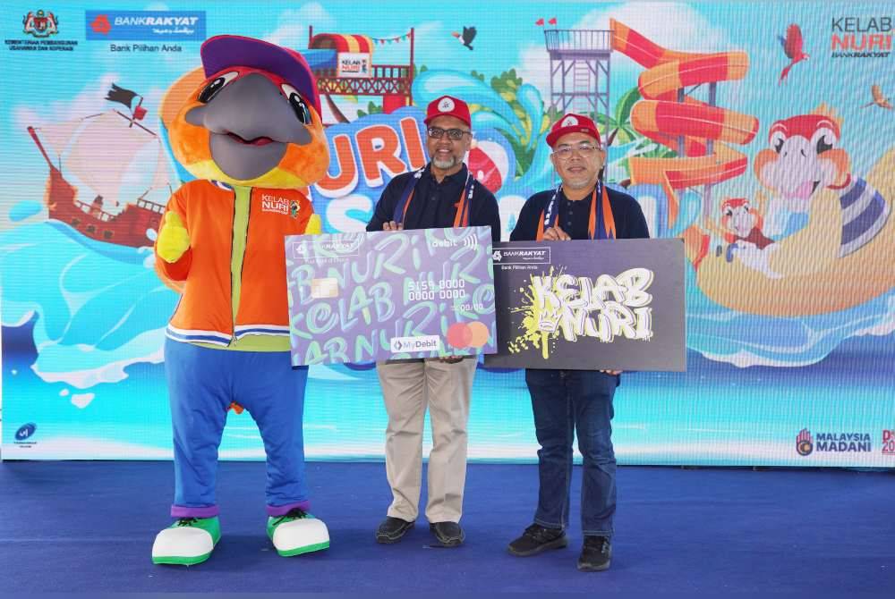 Mohd Irwan (tengah) dan Mohammad Hanis menunjukkan kad Debit-i Nuri dan kad keahlian Kelab Nuri yang kini berwajah baharu.