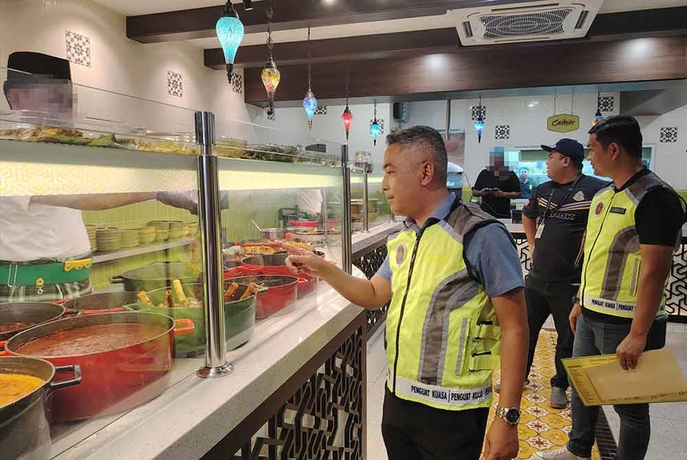 Mohd Sabri bersama pegawainya memeriksa premis restoran di sekitar Bukit Bintang, Kuala Lumpur pada Selasa.