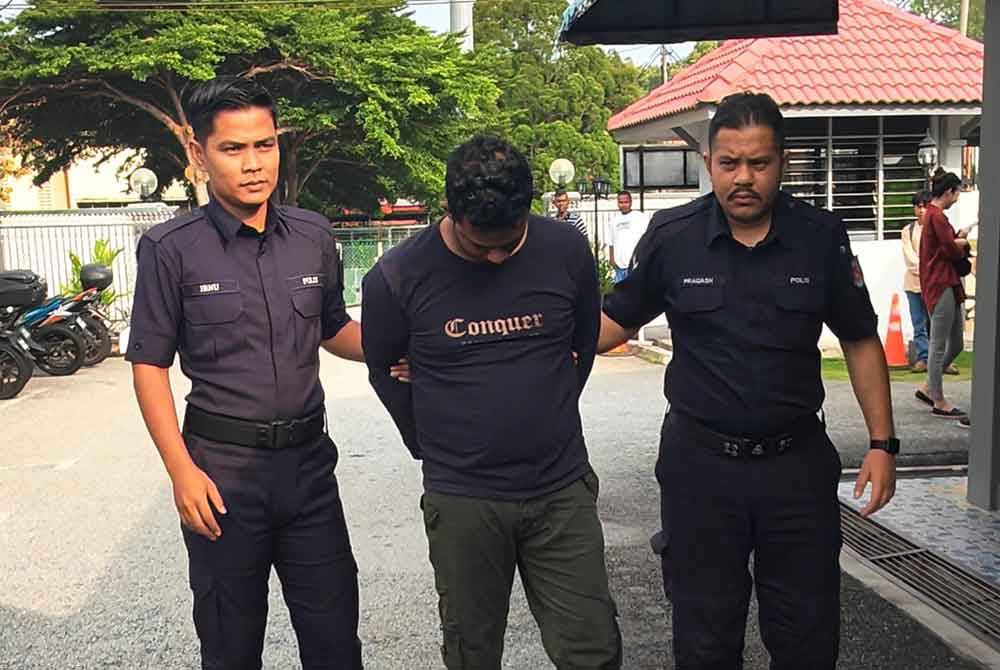 Kalithosan (tengah) diiringi polis ketika hadir ke mahkamah.