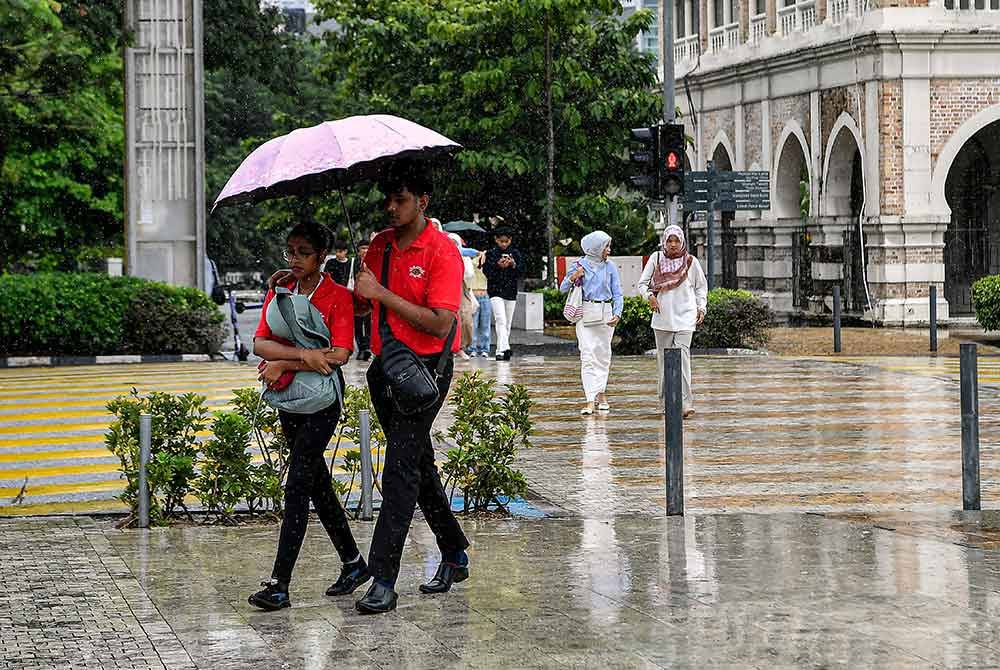 Orang awam meredah hujan lebat ketika tinjauan foto Bernama di sekitar ibu kota hari ini.