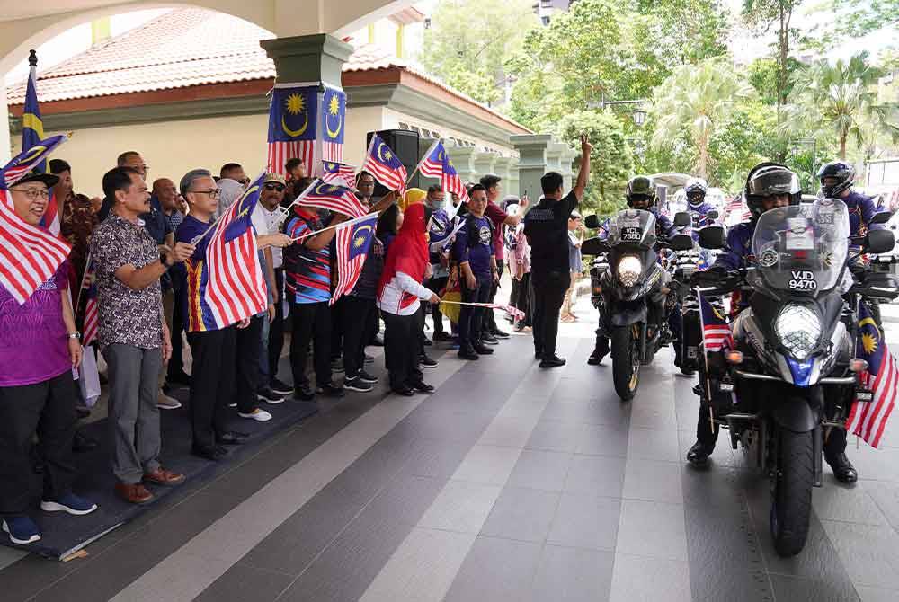 Fahmi Fadzil melakukan pelepasan 'Flag Off' pada Majlis Pelancaran dan Pelepasan Konvoi Kembara Merdeka Jalur Gemilang 2024 (KMJG2024) Peringkat Wilayah Persekutuan Kuala Lumpur di Pusat Komuniti Lembah Pantai pada Sabtu.- FOTO: SINAR HARIAN/ ROSLI TALIB.