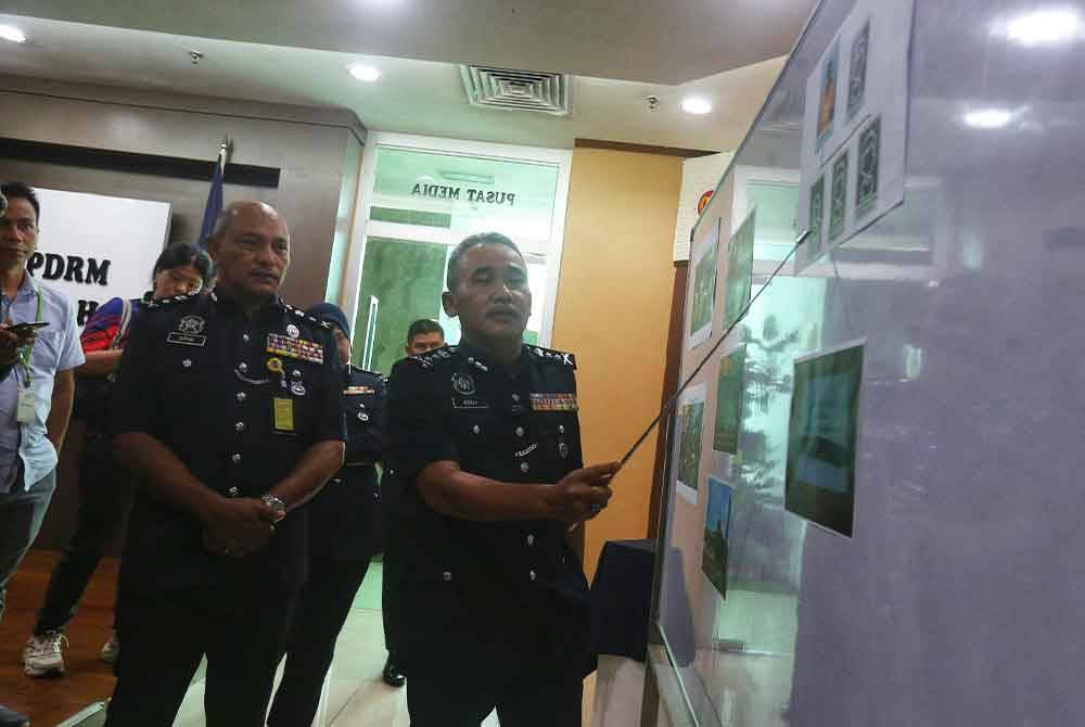 Adzli menunjukkan gambar lokasi kejadian pembunuhan melibatkan warga asing pada Ahad.