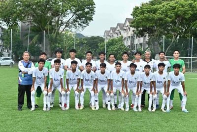 Kamal (barisan belakang, kiri) bersama pemain-pemain SMK TTDI Jaya sebelum perlawanan separuh akhir Piala Datuk Mokhtar Dahari B-18 menentang SMK Bukit Jelutong pada Jumaat.