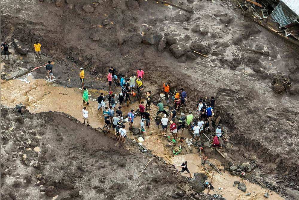 Anggota penyelamat dan penduduk mencari mangsa banjir kilat di Rua, Pulau Ternate, kira-kira 3188 kilometer timur laut Jakarta, Indonesia pada Ahad. Foto EPA