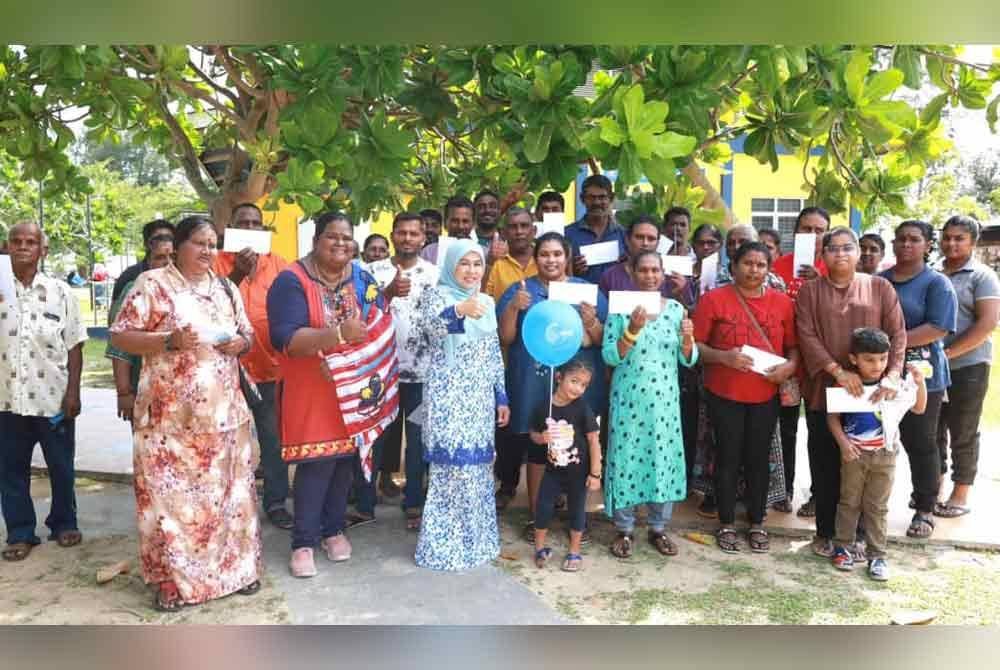 Faizah (empat dari kiri) bersama penerima sumbangan bantuan bakul makanan.