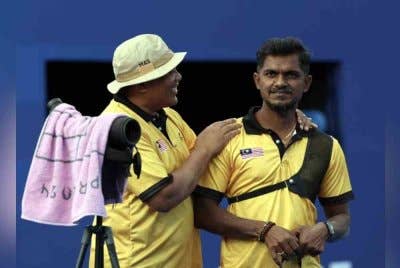 Suresh (kanan) diberi kata-kata semangat oleh jurulatih selepas kalah menentang pemanah Iran Mohammad Reza Arab Ameri dalam pusingan penyingkiran 1/8 recurve individu lelaki terbuka Sukan Paralimpik Paris 2024 di Stade de France hari ini. Foto Bernama