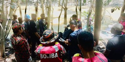 Anggota bomba mengangkat mayat mangsa. 