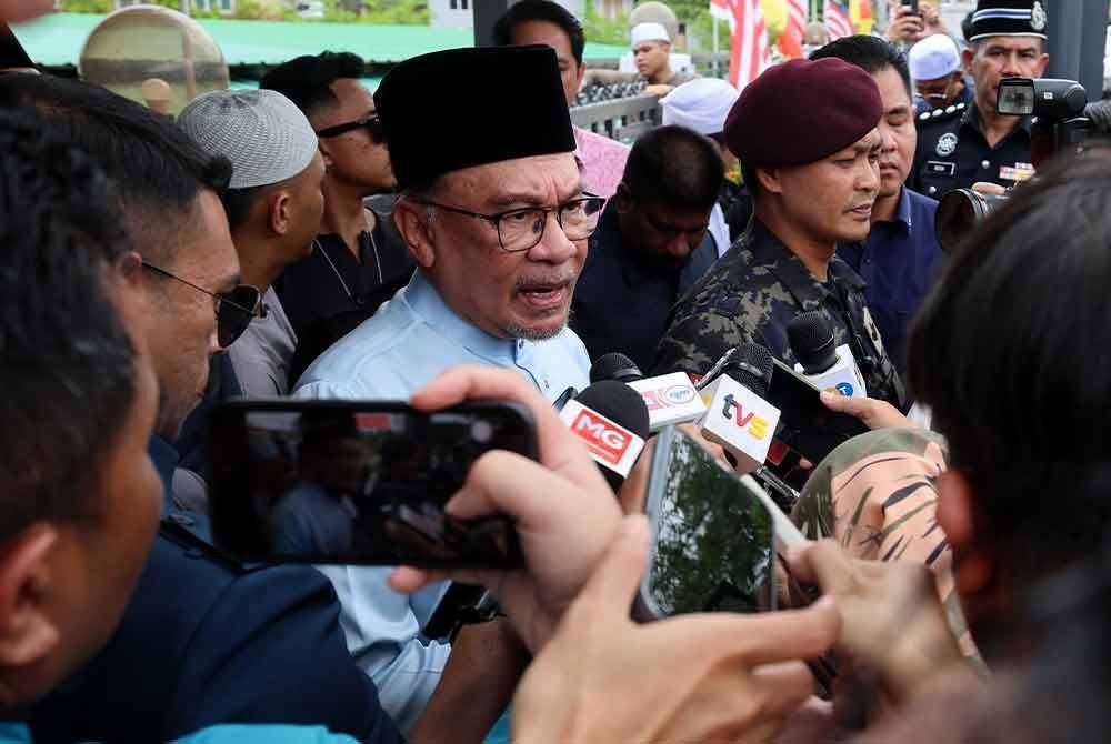Anwar (tengah) ketika ditemui media selepas menunaikan solat Jumaat di Masjid Al-Iman, Kampung Desa Putra, Sungai Merab, Kajang. Foto Bernama