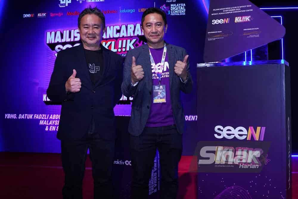 Fadzli (kiri) dan Syamil Fahim pada Majlis Pelancaran aplikasi seeNi dan portal Kliik di Pusat Konvensyen Kuala Lumpur pada Jumaat. Foto Sinar Harian-MOHD HALIM ABDUL WAHID