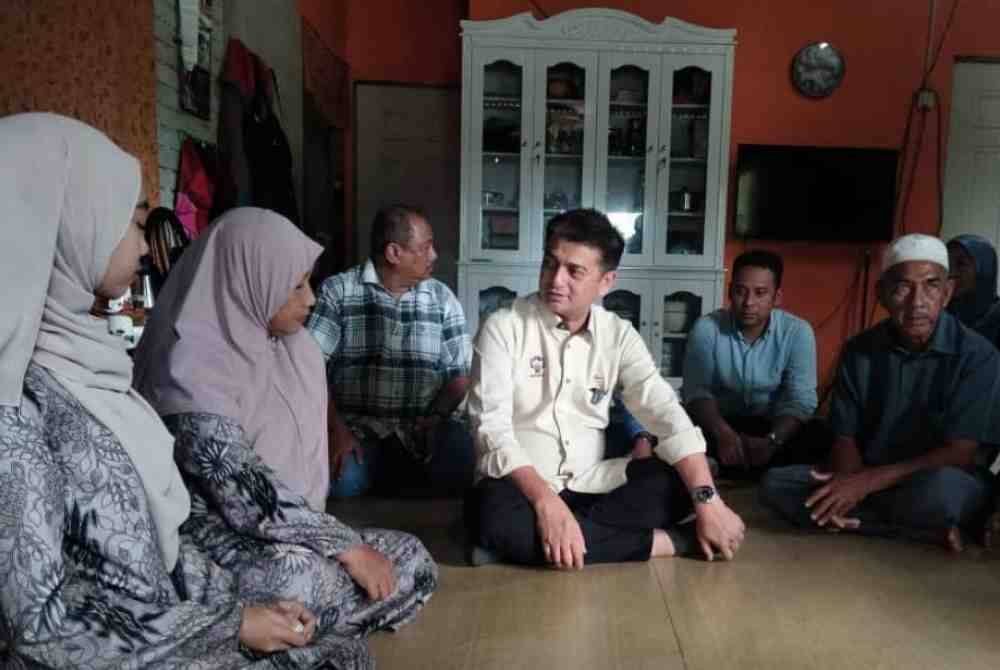 Muhammad Faiz (tengah) bertanya khabar Wan Nur’alyaa Syaza ketika melawat pelajar itu di Kampung Air Tawar pada Selasa.