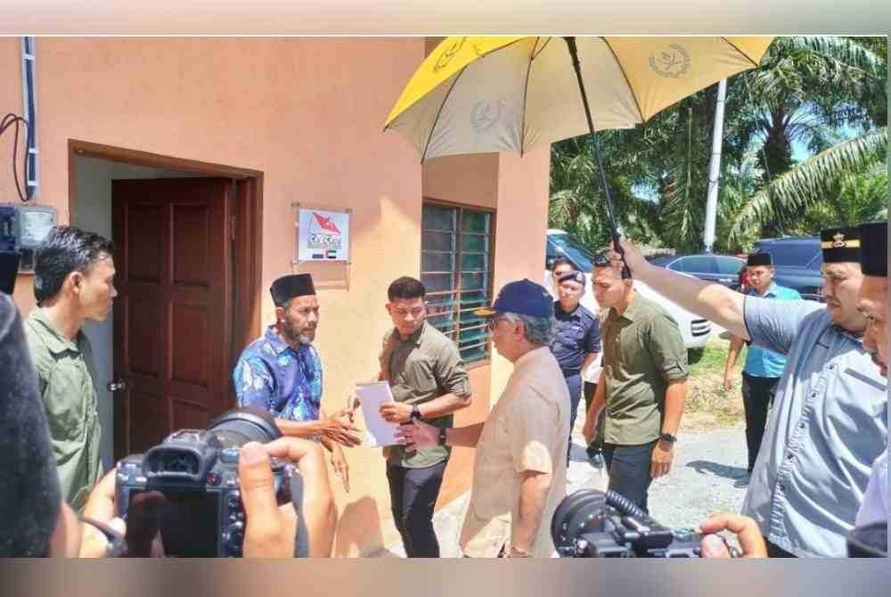Al-Sultan Abdullah mencemar duli mengunjungi rumah Rahim (kiri) selepas penyerahan kunci rumah Ru'Rasa di Kampung Paya Serai, Bera pada Khamis.