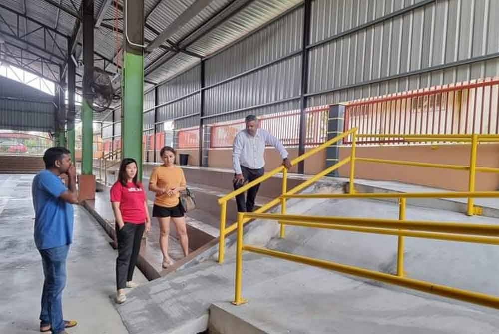 Arul Kumar (kiri) ketika meninjau kerja-kerja menaiktaraf gelanggang bola keranjang di Pekan Mantin.scx