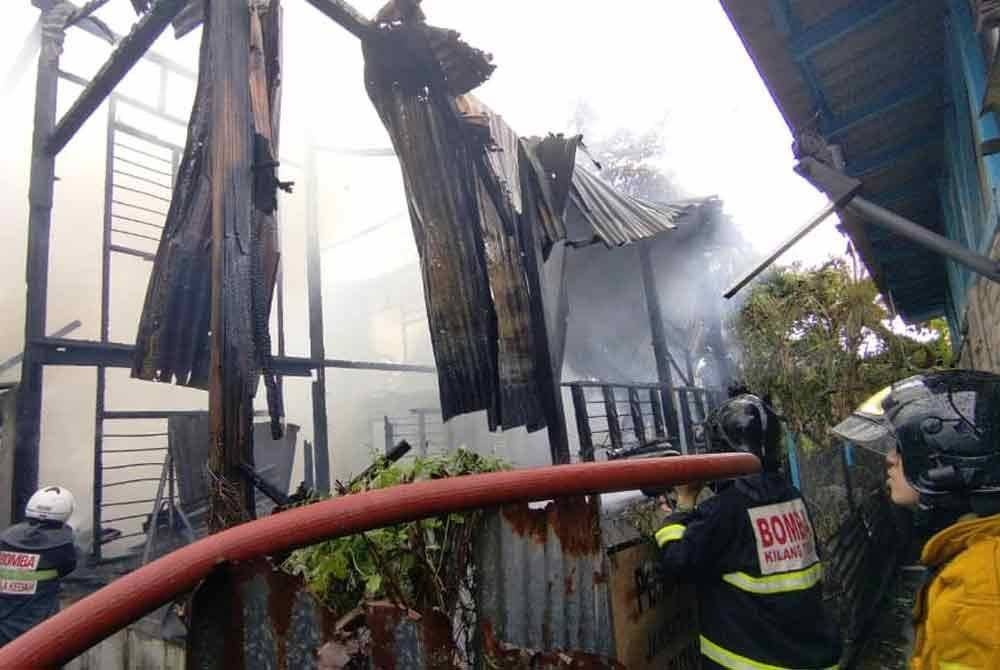 Anggota bomba memadam api kebakaran di rumah sewa Salmah di Tongkang Yard, Alor Setar pada Selasa. Foto Bomba