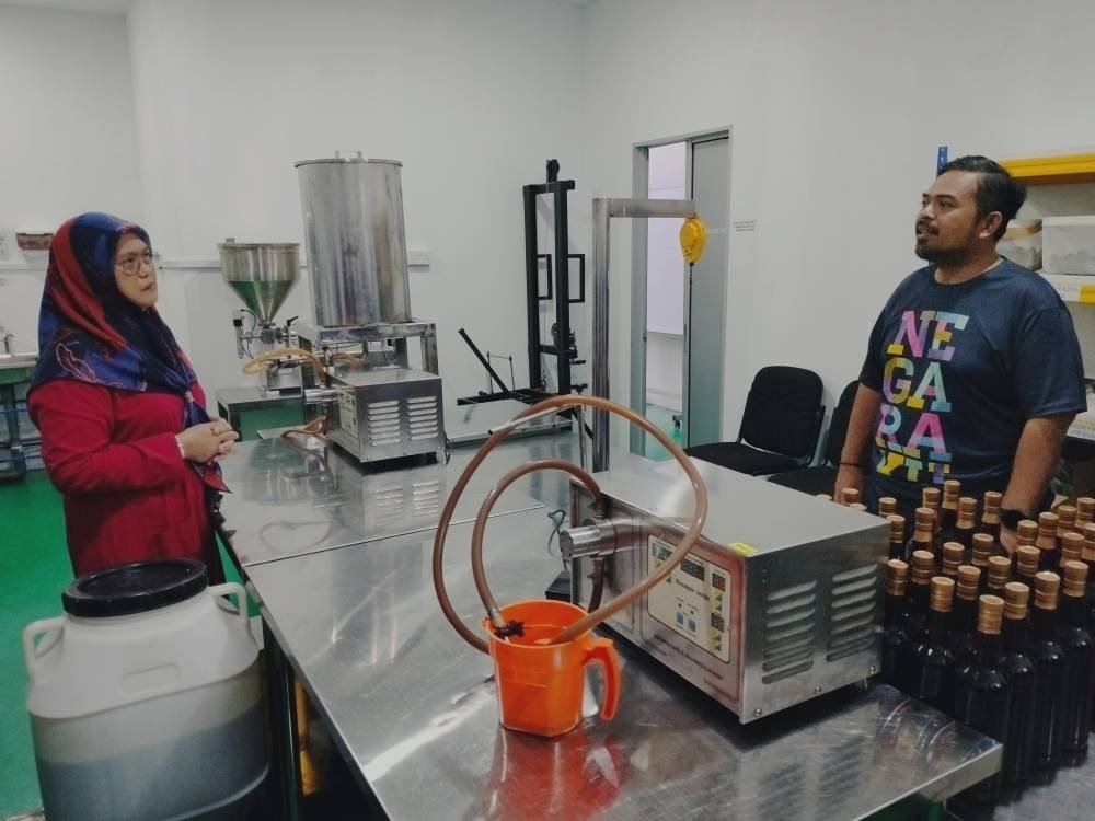 Manndzri (kanan) melawat bengkel pemprosesan jus madu epal di Taman Sri Intan Kluang.