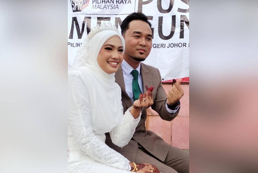 Nurarissa Shazni dan suaminya, Mohammad Hafizzudin setelah selesai mengundi di pusat pengundian Sekolah Agama Gunung Lambak, petang tadi.