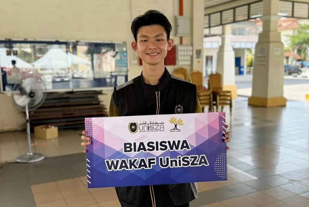 Aaron Lim memegang plakad Biasiswa Wakaf UniSZA ketika ditemui pada Majlis Pendaftaran Pelajar Baharu Ijazah Sarjana Muda UniSZA Sesi Kemasukan 2024/2025, di Kampus Gong Badak, Kuala Nerus pada Ahad.