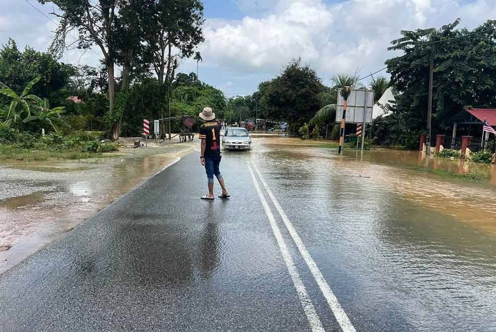 Laluan di Jalan Derang menuju Pokok Sena dinaiki air disebabkan air sungai di Kampung Bukit dan Kampung Menerong di Mukim Derang semakin meningkat pada Isnin. Foto: Urus Setia Penerangan Darul Aman