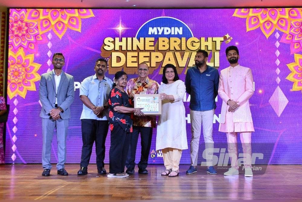 Saraswathy (tiga dari kanan) menyampaikan bakul makanan kepada salah seorang penerima disaksikan Ahimmat (tengah) sempena majlis pelancaran kempen ‘Shine Bright This Deepavali’ pada Selasa. Foto Sinar Harian ASRIL ASWANDI SHUKOR