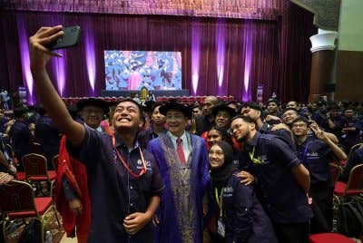 Hajiji beramah mesra bersama penuntut baharu UMS pada Majlis Akujanji dan Ikrar Pelajar UMS di Dewan Canselor UMS pada Selasa. Foto Bernama