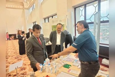 Dr Zaini (kiri) mendengar maklumat mengenai pencuci luka selepas merasmikan Seminar 'Burn Talk, Back to Basic: Rivitalizing Core Competencies in Burn Management' di sini pada Sabtu.