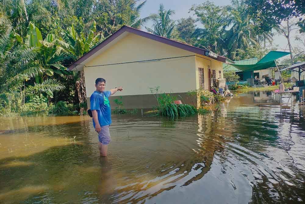 Mohd Sani menunjukkan keadaan rumah di Kampung Parit Yassin Darat, Benut yang dilanda banjir sejak Sabtu.