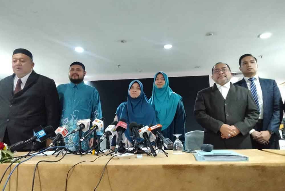 Ashaari Muhammad, Ummu Mubarokah (tiga dari kiri), dan Khaulah (tiga dari kanan) pada sidang media di sebuah hotel di Shah Alam pada Isnin.