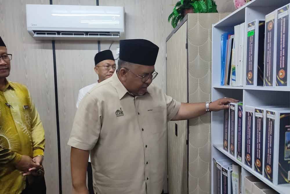 Dr Abd Ghani (kanan) melihat fail-fail disusun di Kabin Guru KAFA SK Pokok Sena.