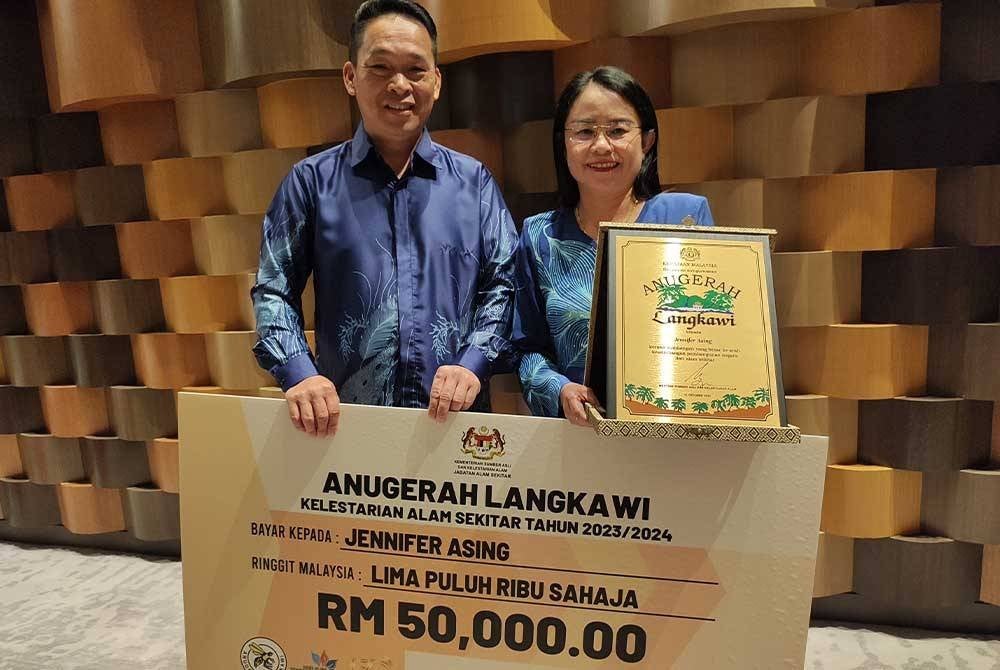Jennifer (kanan) ditemani suaminya, Daim Balingi (kiri) terharu menerima Anugerah Langkawi–Kelestarian Alam Sekitar (ALKAS) bagi kategori individu sempena Sambutan Hari Alam Sekitar Negara (HASN) 2024 Peringkat Kebangsaan pada malam Isnin.