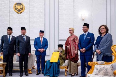 Yang di-Pertuan Agong Sultan Ibrahim (tiga dari kiri)berkenan mengurniakan watikah pelantikan profesor diraja kepada tokoh intelek Islam Tan Sri Dr Syed Muhammad Naquib Al-Attas (duduk) di Istana Negara pada Rabu.