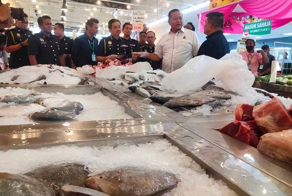 Rizam (dua, kanan) ketika mengetuai pemeriksaan pematuhan di Pasaraya Econsave Pandamaran, Klang pada Isnin.