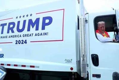 Lori sampah dipandu Trump tertera slogan popular beliau, Make America Great Again. Foto Agensi