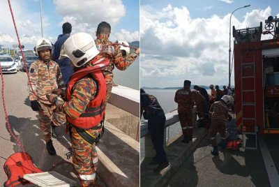 Anggota bomba melakukan kerja-kerja menyelamatkan wanita yang terjatuh dari Jambatan Pulau Pinang.