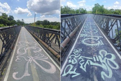 Laluan Jambatan Besi Kereta Api Kampung Bahagia di sini yang diconteng suspek sebelum diberkas polis pada malam Sabtu.