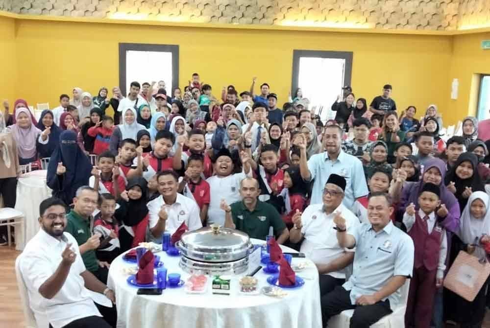 Penduduk bergambar selepas Majlis Pelancaran Program Santuni Madani di Dewan Hassan Abdullah, Kampung Pasir Johor Bahru pada Ahad.