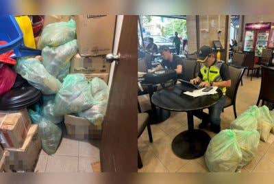 Antara minyak masak paket yang ditemui disembunyikan dalam storq sebuah restoran di ibu kota dalam serbuan pada Jumaat.