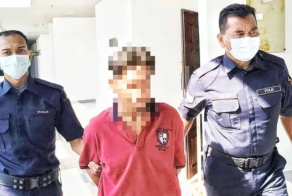 Lelaki berusia 46 tahun (tengah) ketika dibawa keluar dari Mahkamah Sesyen Melaka pada Khamis.