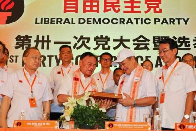 Su Pin menyampaikan cenderamata kepada Pengerusi Gabungan Rakyat Sabah (GRS), Datuk Seri Hajiji Noor yang hadir pada Mesyuarat Agung LDP di Dewan Sekolah Menengah Kian Kok, Kota Kinabalu.