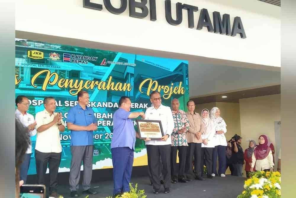 Dzulkefly (kanan) menerima cenderahati daripada Alexander selepas Majlis Penyerahan Projek Hospital Seri Iskandar dan Blok Tambahan HSM di HSI di sini, pada Khamis.