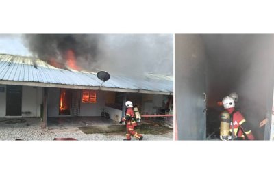 Anggota bomba memadam kebakaran melibatkan lapan rumah sewa di Kampung Parit Semarang, Batu Pahat. Foto JBPM