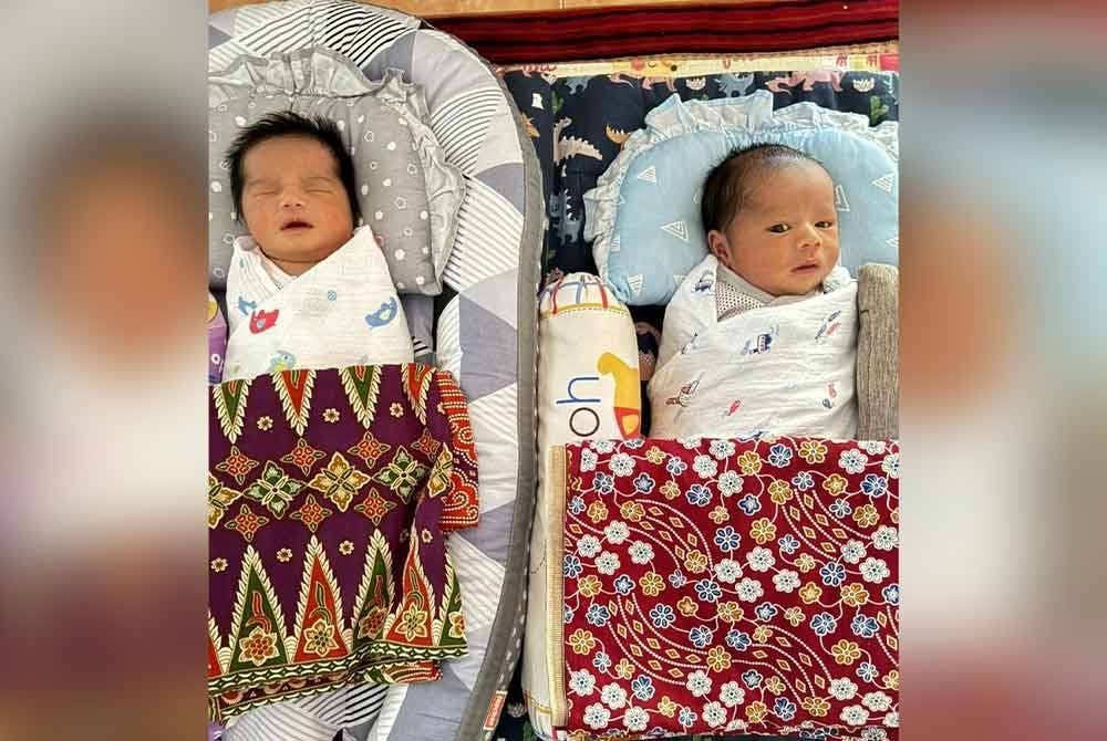 Pasangan bayi kembar tidak seiras berusia sebulan, Sayf Naufal Muhammad Syamil (kanan) memerlukan bantuan dana RM105,000 bagi menjalani pembedahan akibat penyakit jantung berlubang.