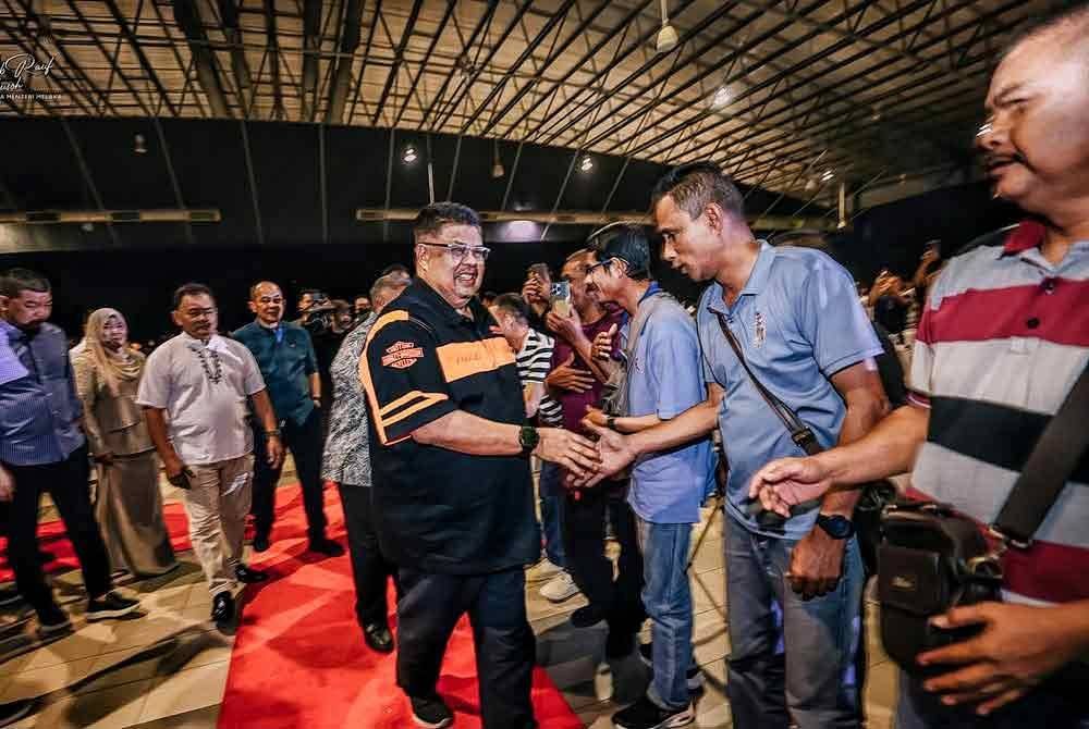 Ab Raif (tengah) bersalaman dengan pekerja pembersihan dari pelbagai agensi yang diraikan pada majlis itu.