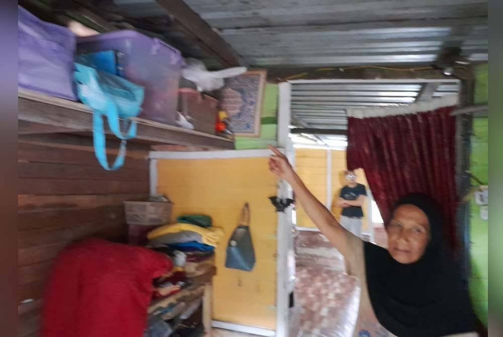 Zaleha menunjukkan barangan dan dokumen penting diletakkan di tempat tinggi bagi menghadapi banjir di Kampung Jasa Sepakat, Pekan Nanas, di Pontian.