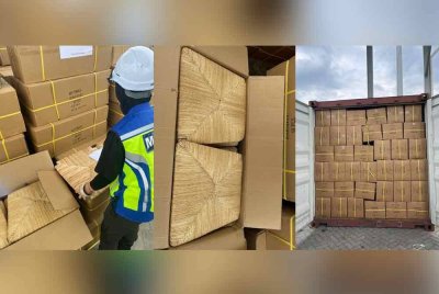 Pegawai Maqis memeriksa kontena mengandungi produk kayu dari China tanpa permit import cuba dibawa masuk melalui Pelabuhan Pasir Gudang. Foto Maqis