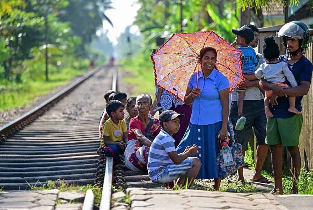 Saudara mara menunggu kereta api 'Queen of the Sea' yang akan membawa mereka ke tugu peringatan yang terletak di Peraliya. - AFP