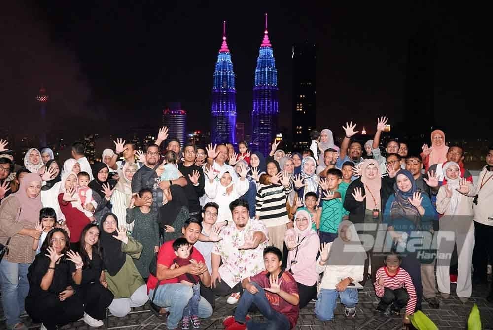 Kakitangan dan ahli keluarga Felda bergambar melepas menyaksikan pertunjukan bunga api yang menghiasi ibu kota Kuala Lumpur sempena ambang Tahun Baharu 2025 yang dirakam dari Tingkat 50, Menara Felda, Kuala Lumpur. FOTO SINAR HARIAN-ROSLI TALIB
